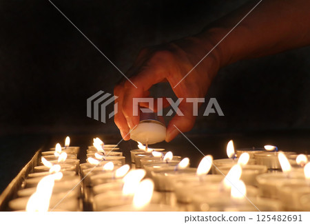 Lighting church candles Lighting church candles 125482691