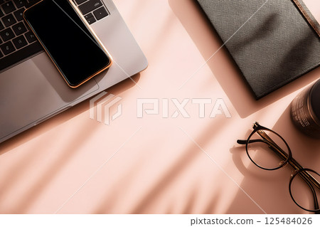 Minimalist workspace: flat lay of laptop, smartphone, notebook and glasses 125484026