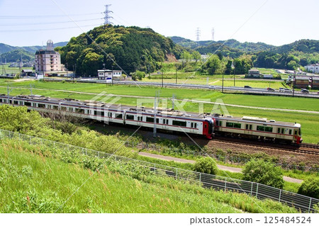Meitetsu 2000 series express train running through fresh greenery 125484524