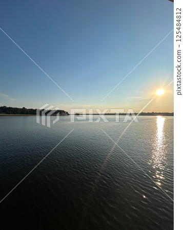 Sunset Over Cedar Creek Reservoir in Texas with Vibrant Water Reflections Sunset Over Cedar Creek Reservoir in Texas with Vibrant Water Reflections 125484812
