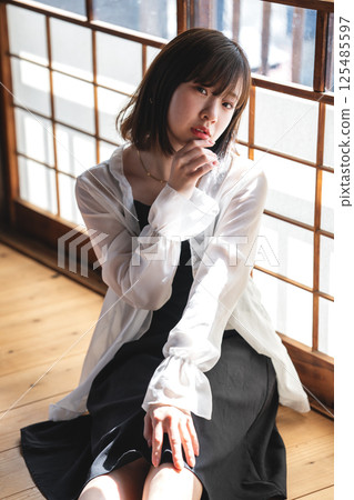 A cool young woman relaxing in a Japanese-style room A cool young woman relaxing in a Japanese-style room 125485597