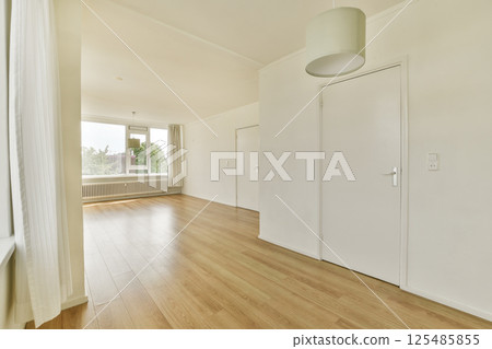 A spacious interior featuring elegant flooring and natural light streaming through large windows, creating a warm and inviting atmosphere. A spacious interior featuring elegant flooring and natural light streaming through large windows, creating a warm and inviting atmosphere. 125485855