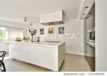 A sleek and contemporary kitchen featuring clean lines, a spacious island, and stylish decor elements. The bright space emphasizes functionality and aesthetics. A sleek and contemporary kitchen featuring clean lines, a spacious island, and stylish decor elements. The bright space emphasizes functionality and aesthetics. 125486090