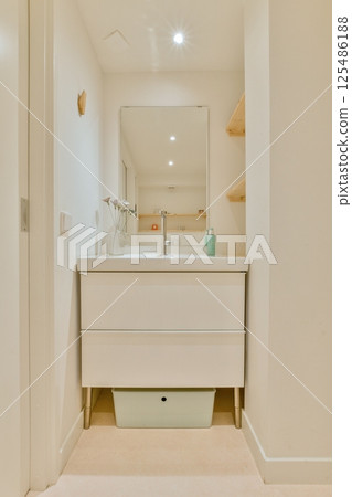 A sleek, modern bathroom featuring a large mirror, minimalist cabinetry, and soft lighting, creating an inviting atmosphere. Designed for functionality and aesthetics. A sleek, modern bathroom featuring a large mirror, minimalist cabinetry, and soft lighting, creating an inviting atmosphere. Designed for functionality and aesthetics. 125486188