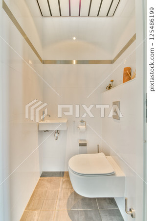 A sleek, modern bathroom featuring minimalist design elements, clean lines, and a bright, airy atmosphere, perfect for relaxation and comfort. 125486199