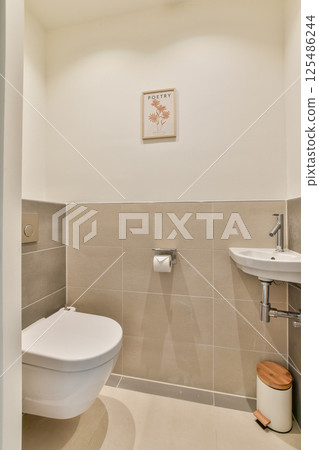 This contemporary bathroom features a sleek and minimalist design with neutral colors and modern fixtures, embodying a clean and elegant aesthetic. 125486244