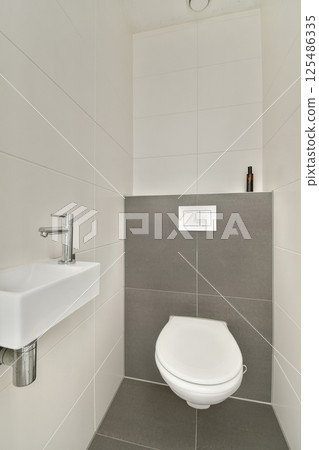 A sleek and contemporary bathroom featuring a minimalist aesthetic with clean lines and neutral tones. The design highlights functional elegance. A sleek and contemporary bathroom featuring a minimalist aesthetic with clean lines and neutral tones. The design highlights functional elegance. 125486335