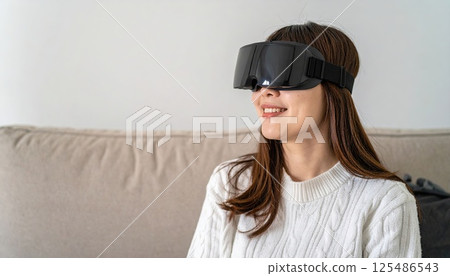 AI image: A woman enjoying virtual reality in her living room using a head-mounted display 125486543
