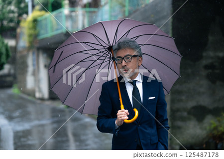 A man with an umbrella A man with an umbrella 125487178