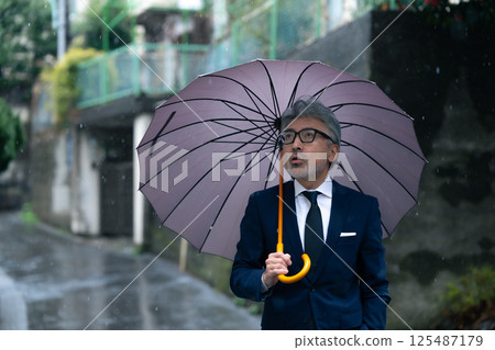 A man with an umbrella 125487179