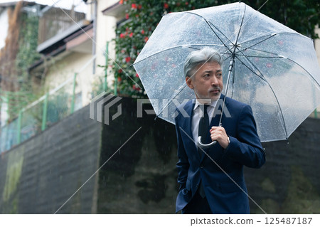 A man with an umbrella A man with an umbrella 125487187