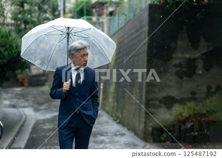 A man with an umbrella 125487192