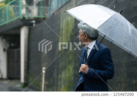 A man with an umbrella A man with an umbrella 125487200