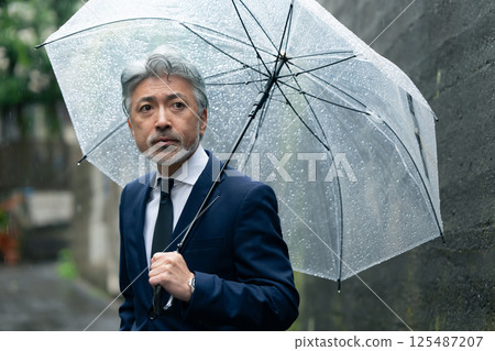 A man with an umbrella 125487207