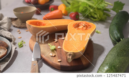 Autumn vegetables arranged on a kitchen worktop 125487471