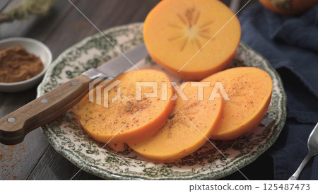 Orange persimmons Orange persimmons 125487473