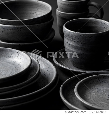 Dark gray stoneware dishes including plates, bowls, and mugs Dark gray stoneware dishes including plates, bowls, and mugs 125487815