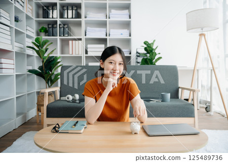 Women are putting coins in a piggy bank for a business that grows for profit and saving money for the future. planning for retirement concept 125489736