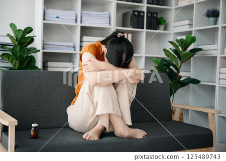 Asian woman sit Depression Dark haired pensive glance Standing by window and anxiety Copy space. Asian woman sit Depression Dark haired pensive glance Standing by window and anxiety Copy space. 125489743