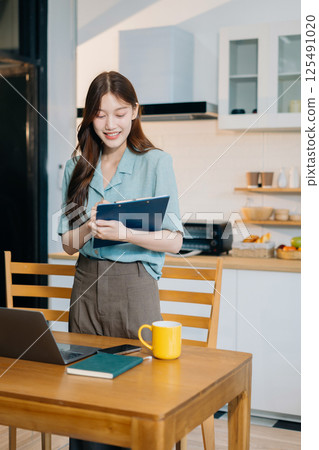 Successful, happy woman working online from home, lifestyle and small business. 125491020