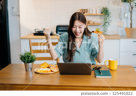 Successful, happy woman working online from home, lifestyle and small business. Successful, happy woman working online from home, lifestyle and small business. 125491022