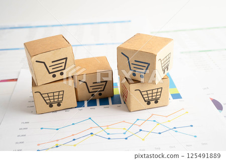 Online shopping, Shopping cart box on business graph, import export, finance commerce. Online shopping, Shopping cart box on business graph, import export, finance commerce. 125491889