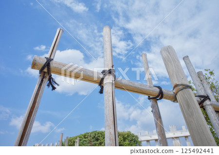 Wooden fence under blue sky and white clouds 125492441