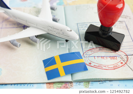 Sweden flag and passport with airplane for travel. Sweden flag and passport with airplane for travel. 125492782