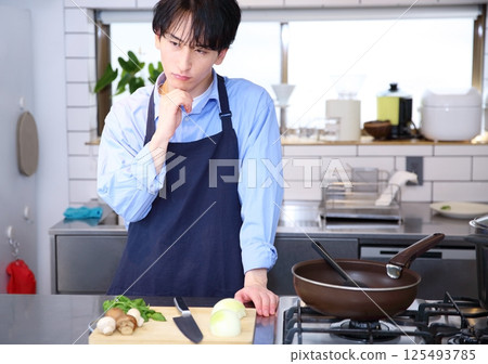 Image of a worried man in the kitchen Image of a worried man in the kitchen 125493785