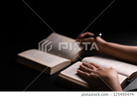 Woman of faith holds the Bible in her hand, believing deeply in the teachings of Jesus Christ and the presence of God, embodying her Christian religion. bible, person, hand, religion, book, faith. 125495474