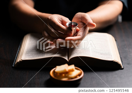Sacred ceremony of Communion, Christians express their faith by partaking in holy bread, deepening their spiritual connection with God within the church. communion, religion, christian, faith, holy. Sacred ceremony of Communion, Christians express their faith by partaking in holy bread, deepening their spiritual connection with God within the church. communion, religion, christian, faith, holy. 125495546