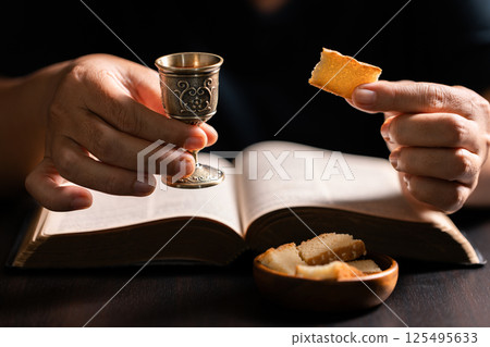 Sacred ceremony of Communion, Christians express their faith by partaking in holy bread, deepening their spiritual connection with God within the church. communion, religion, christian, faith, holy. 125495633
