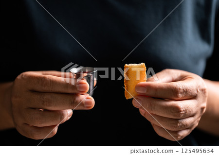 Sacred ceremony of Communion, Christians express their faith by partaking in holy bread, deepening their spiritual connection with God within the church. communion, religion, christian, faith, holy. Sacred ceremony of Communion, Christians express their faith by partaking in holy bread, deepening their spiritual connection with God within the church. communion, religion, christian, faith, holy. 125495634