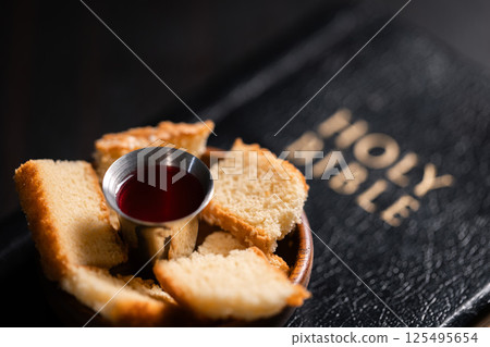 Communion, Christians celebrate their faith by partaking in bread and wine, symbolizing the body and blood of Jesus Christ, as taught in the Bible and cherished in their holy religion. communion, holy Communion, Christians celebrate their faith by partaking in bread and wine, symbolizing the body and blood of Jesus Christ, as taught in the Bible and cherished in their holy religion. communion, holy 125495654