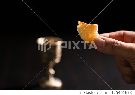 Sacred ceremony of Communion, Christians express their faith by partaking in holy bread, deepening their spiritual connection with God within the church. communion, religion, christian, faith, holy. 125495658