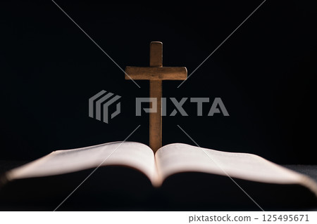 Cross is central symbol in the Bible, representing Jesus Christ and the Christian faith, and is revered in church as a holy emblem of religion and devotion to God. bible, cross, jesus christ, book. Cross is central symbol in the Bible, representing Jesus Christ and the Christian faith, and is revered in church as a holy emblem of religion and devotion to God. bible, cross, jesus christ, book. 125495671