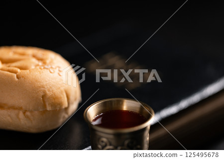 Communion, Christians celebrate their faith by partaking in bread and wine, symbolizing the body and blood of Jesus Christ, as taught in the Bible and cherished in their holy religion. communion, holy 125495678