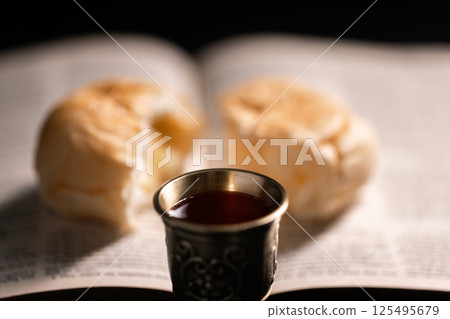 Communion, Christians celebrate their faith by partaking in bread and wine, symbolizing the body and blood of Jesus Christ, as taught in the Bible and cherished in their holy religion. communion, holy Communion, Christians celebrate their faith by partaking in bread and wine, symbolizing the body and blood of Jesus Christ, as taught in the Bible and cherished in their holy religion. communion, holy 125495679