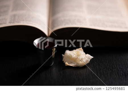 Communion, Christians celebrate their faith by partaking in bread and wine, symbolizing the body and blood of Jesus Christ, as taught in the Bible and cherished in their holy religion. communion, holy 125495681