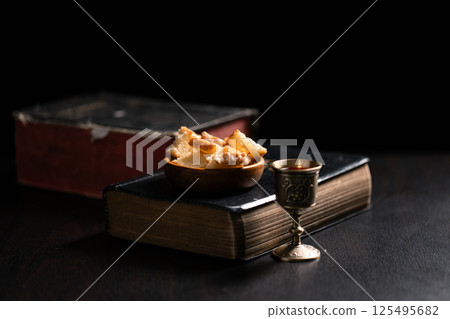 Communion, Christians celebrate their faith by partaking in bread and wine, symbolizing the body and blood of Jesus Christ, as taught in the Bible and cherished in their holy religion. communion, holy 125495682