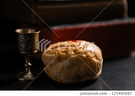 Communion, Christians celebrate their faith by partaking in bread and wine, symbolizing the body and blood of Jesus Christ, as taught in the Bible and cherished in their holy religion. communion, holy 125495685
