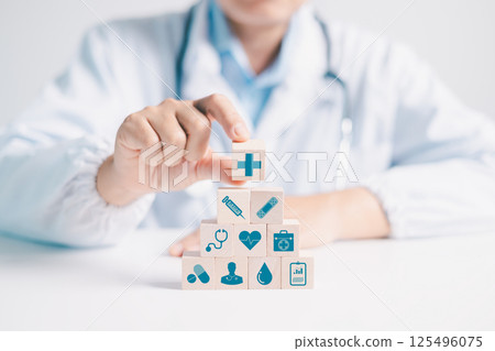 Doctor explains concept of disease management and insurance coverage to person, highlighting importance of medicine and care within business of hospital services. disease, medicine, block, insurance. 125496075