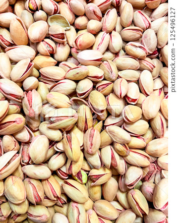 Abundance of raw pistachios with natural delicate pink hues in close up view 125496127