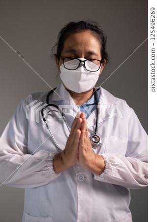 Doctor prays for the health of the person under their care, as medicine, nurses, and health care at the hospital work together to fight the disease. doctor, pray, health, person, medicine, care. Doctor prays for the health of the person under their care, as medicine, nurses, and health care at the hospital work together to fight the disease. doctor, pray, health, person, medicine, care. 125496269
