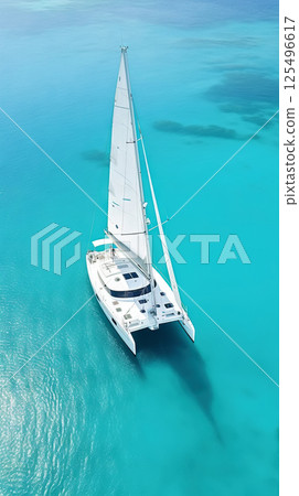 Aerial image of beautiful sailboat cruising in blue open ocean. Luxury white yacht. Generative AI 125496617