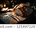 Artisan bread in a dark, moody bakery scene, highlighted by dramatic lighting. 125497120