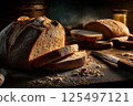 Artisan bread in a dark, moody bakery scene, highlighted by dramatic lighting. 125497121