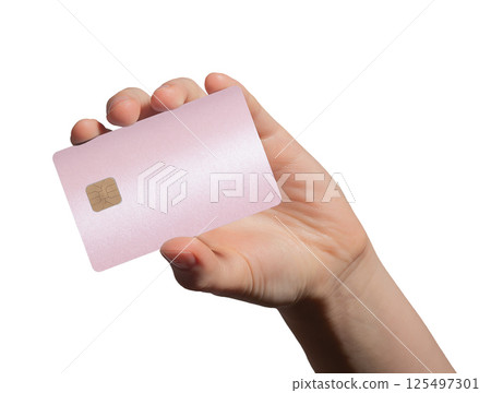 Card in female hand. Pink plastic bankcard for smart shopping, debit or credit payment, 125497301