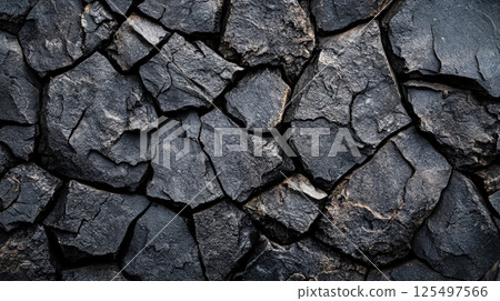 Close up of a rock wall with many cracks and holes 125497566