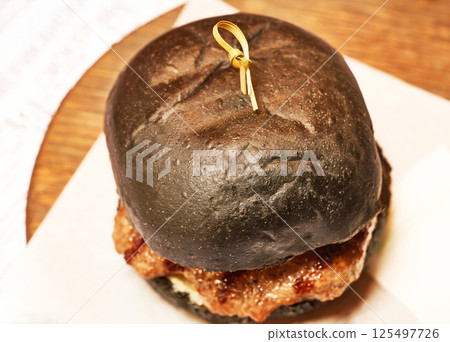 Black Hamburger close-up. Fast food. 125497726